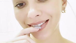 A student washes herself in a bathtub with foam. Light erotica