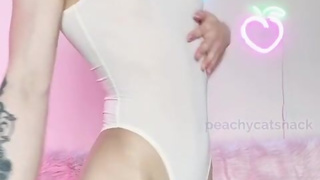 Petite and cute Asian girl shows off her fit body in a see through leotard and flashes her pussy