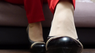 Sexy girl in pants pantyhose shoes shows her legs foot feet fetish