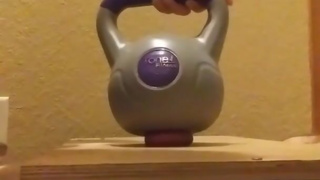 Wife crushes balls with kettle bells