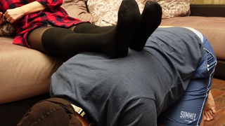 A slave in a collar is kneeling legs in black socks and tights