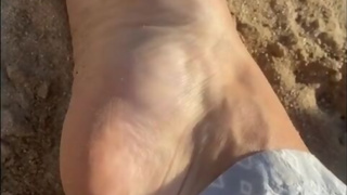 Arching my perfect feet in the sand