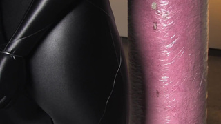 Spandex zentai babe with fishing line tied to concrete post