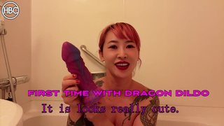 Tattooed Japanese girl masturbates with huge dragon dildo
