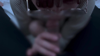 A girl with neat glasses gets ejaculated in the mouth.