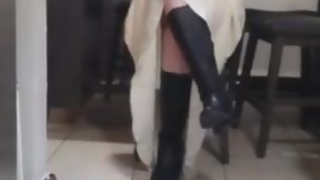 Beautiful blonde bride dangling her long legs in her almost knee high boots