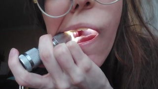 Giantess plays with a tiny in her mouth before swallowing it