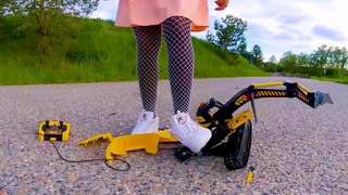 Big excavator is destroyed kicked, trampled, crushed, smashed, crushed, broken plastic car, crush