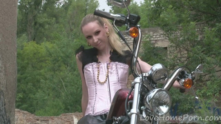 Cute teen is amazed by a big bike