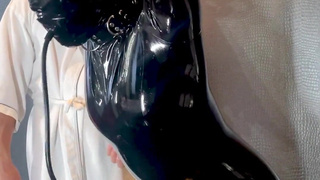 Lift the collar of the suspended latex doll and even more toys make her feel good