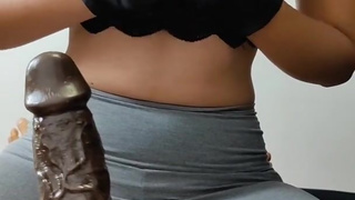 Hot girlfriend puts on black gloves and teases her locked chastity boyfriend with a BBC Strapon