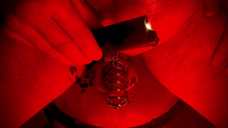 The naughty man gets hot wax on his balls.