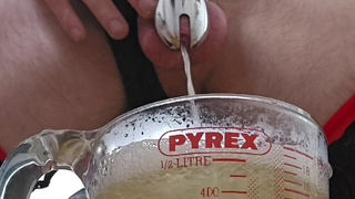 Pissing in a measuring jug with cum still in my urethra wearing sissy lingerie and a chastity cage