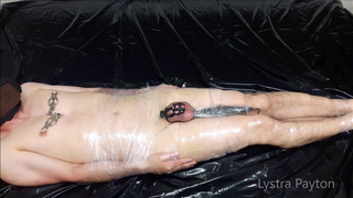 The mistress wraps the slave in plastic wrap and tortures him with vibrations on his full testicles