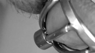 slave tries pissing while locked in new cage with long hollow catheter inside him