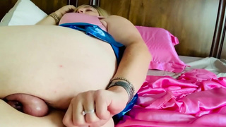 Sissy in shiny blue skirt and pink chastity bangs own hole