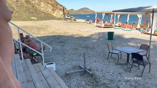 Two girlfriends walk naked on a public beach