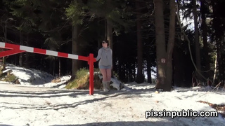 Girls in need skate around in the snow to find a proper place to have a pee