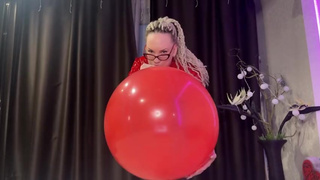 Looner girl in glasses and red PVC dress blow BIG red balloon and pop it with ass. DM to get full