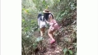 Two lesbian trannies by the cascade outdoors making love