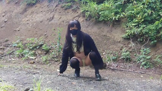 Japanese crossdresser pees openly in the forest for a selfie.