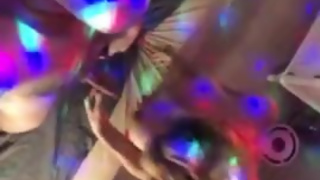 She sucks me on the party while I enjoy the rainbow lights